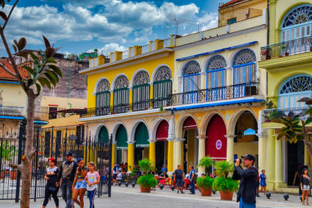 People walking in colorful  Plaza Vieja, located in La Habana vieja area