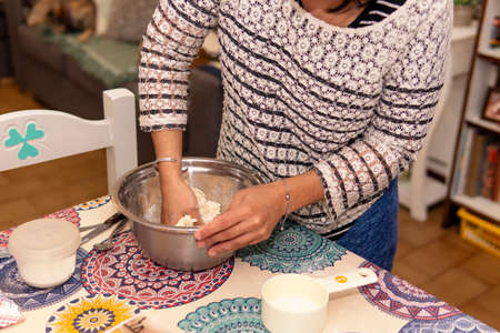A young woman following kneading dough for homemade pastry
