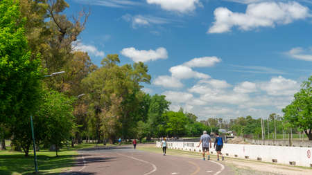 People walking, biking and running in Eva Peron park. Taken on a warm spring morningのeditorial素材