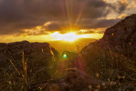 Sunset from Ceferino hill, Sierra de la Ventana. Taken on from the rocky floor looking to the sunの写真素材