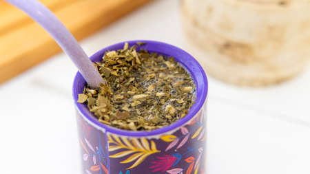 close view of a yerba mate infusion on top of a white table