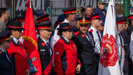 a colorful group of fire man and fire woman watching the volunteers firefighters day paradeのeditorial素材