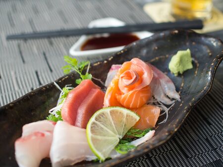 Japanese raw fish on black plate. Also known as Sashimi.の写真素材