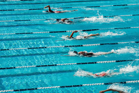 The swimmers competing at a high school meet strive for victory The swimmers competing at a high school meet strive for victory
