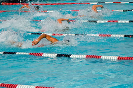 The swimmers compete hard in the high school league championshipsの写真素材
