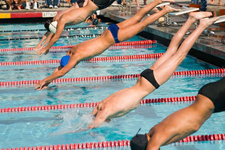 The swimmers compete hard in the high school league championshipsの写真素材