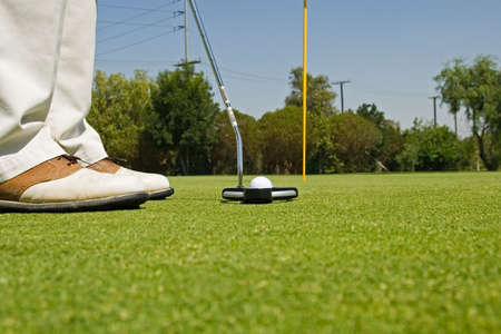 Golf course action and players hitting the greens