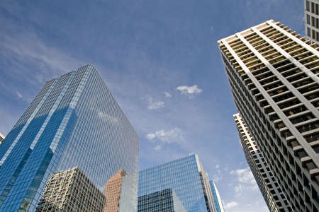 Downtown Calgary office buildings soaring into the skyline while gleaming in the sunの写真素材