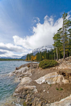 Beautiful Rocky Mountain lake in Alberta, Canada in autumn fall season and storm cloudsの写真素材