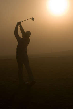 Golfers and a resort golf course in actionの写真素材