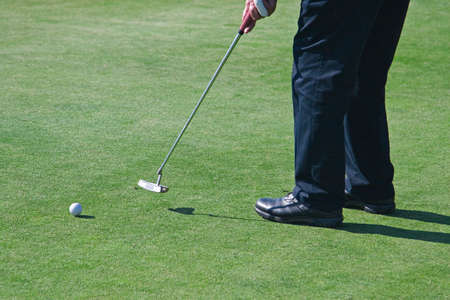 Golfers and golf course action in the morning