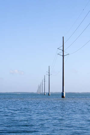 Electric power lines over water in floridaの写真素材
