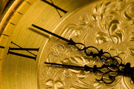 Close up view of an antique clock face with hour and minute handsの写真素材