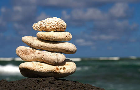 White coral rocks stacked by a meditating zen follower
