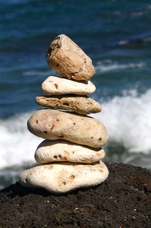 White coral rocks stacked by a meditating zen followerの写真素材