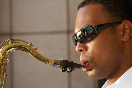 An youung and trendy African-American sax musicianの写真素材