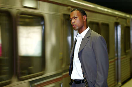 An African-American businessman awaits his commuter trainの写真素材