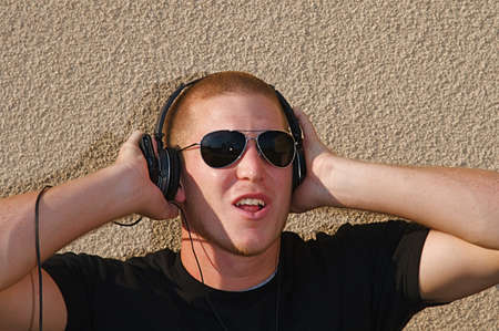 A young college student listens to music on some headphones