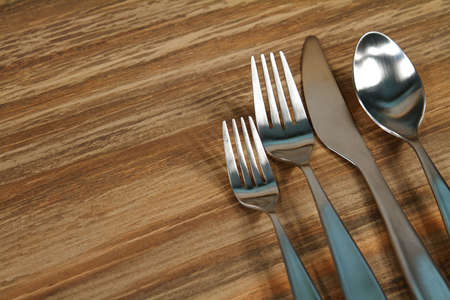 Modern silverware arranged in a place setting on a tableの写真素材