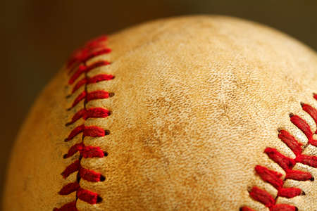 Close up macro view of the seams on a used baseballの写真素材