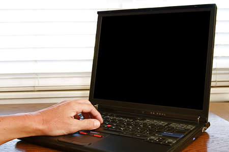 Working on a laptop computer sitting on a desk