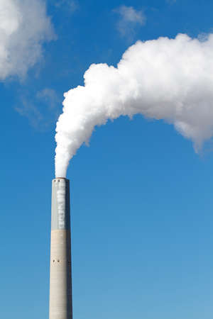 A tall smokestack spewing out dirty polluted smokeの写真素材