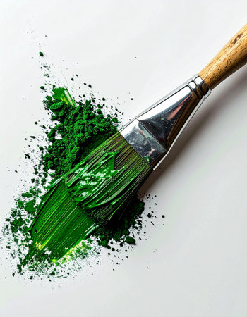 A close-up view captures the dynamic moment an artists brush makes its first vibrant green stroke on a clean white canvas. The thick texture of the paint and the energetic splatter suggest a burst of creative inspiration, the beginning of a new masterpiece.の素材