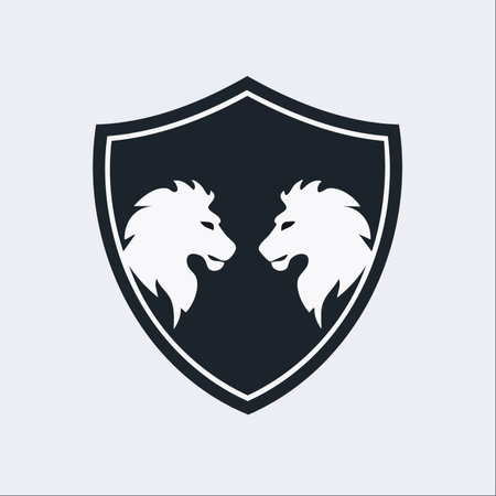 A powerful and elegant emblem featuring two majestic lion heads facing each other within a classic shield.のイラスト素材