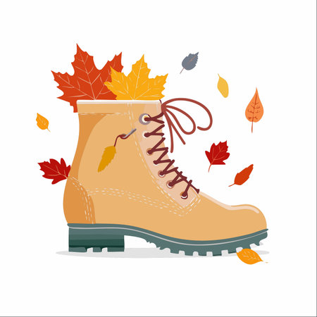 A cozy illustration of a hiking boot filled with colorful autumn leaves, with more foliage gently falling around it.のイラスト素材