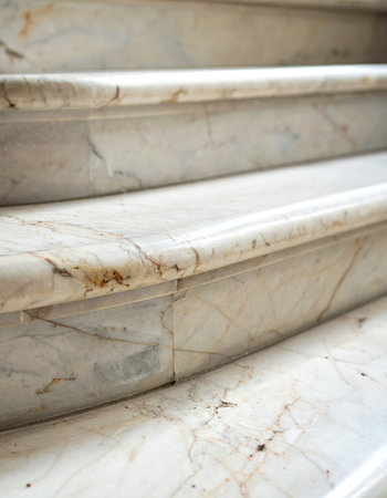 A low-angle, detailed view captures the elegant curve and polished surface of classic marble steps.の素材