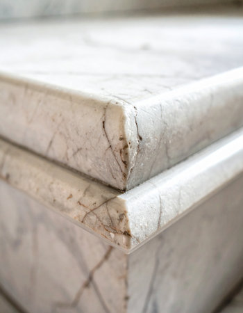 A close-up detail shot captures the weathered corner of a marble surface.の素材