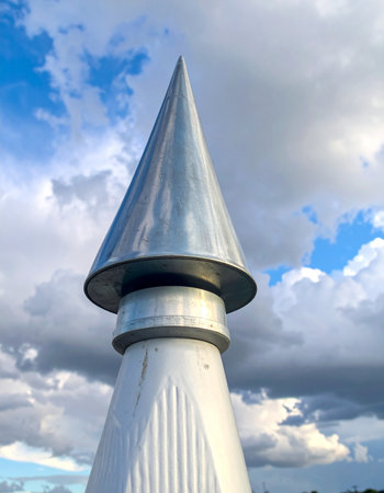 A sleek, metallic cone points decisively towards the heavens, a symbol of modern ambition and progress.の素材