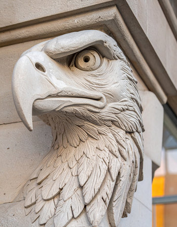 A close-up of a majestic stone eagle sculpture, a timeless guardian watching over the city.の素材
