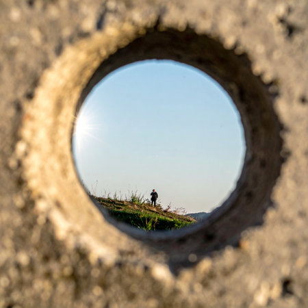 From a hidden vantage point, a lone figure is observed on a distant horizon.の素材