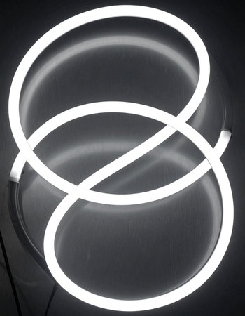 A single, continuous line of pure white light glows softly in the darkness, twisting into an elegant and infinite loop.の素材