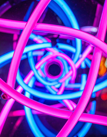 A hypnotic vortex of intertwined pink and blue neon tubes creates a dynamic and futuristic visual.の素材