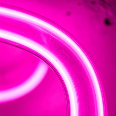 A vibrant burst of electric pink energy radiates from curved neon tubes, creating a dynamic and futuristic abstract background.の素材