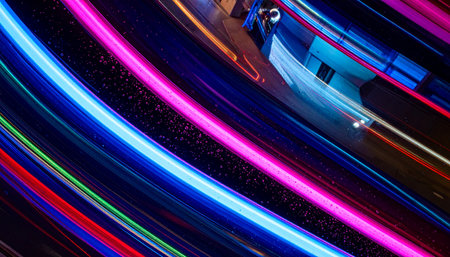 Streaks of vibrant neon light cut through the darkness, capturing the essence of high-speed data transfer in a futuristic digital landscape.の素材