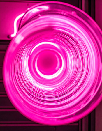 A mesmerizing view into a swirling vortex of electric pink light.の素材