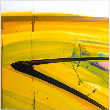 A powerful black brushstroke cuts through a vibrant, chaotic field of yellow, capturing a moment of pure creative energy.の素材