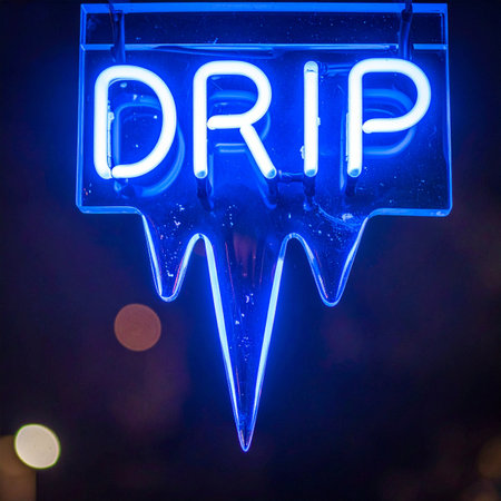 A vibrant blue neon sign cuts through the darkness, spelling out the word 'DRIP' in an electric glow.の素材