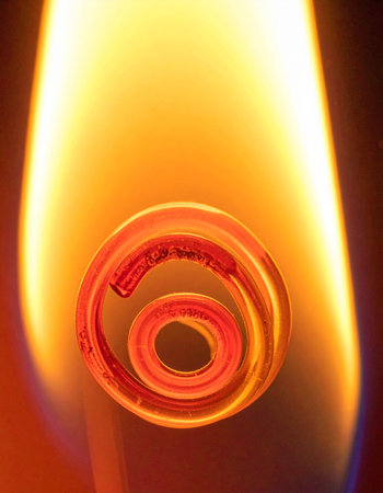 A macro perspective captures the raw power of a heating element glowing red-hot at its core.の素材