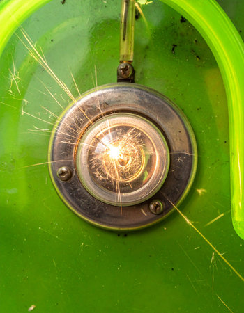 A powerful burst of energy erupts as bright sparks fly from the center of an industrial machine.の素材