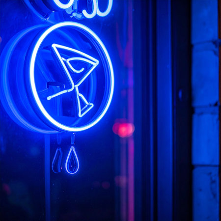 A vibrant blue neon sign of a martini glass glows invitingly in the dark, signaling a stylish spot for evening cocktails and lively conversation.の素材