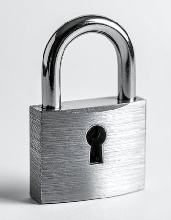 A sturdy, brushed metal padlock stands as a powerful symbol of security and protection.の素材