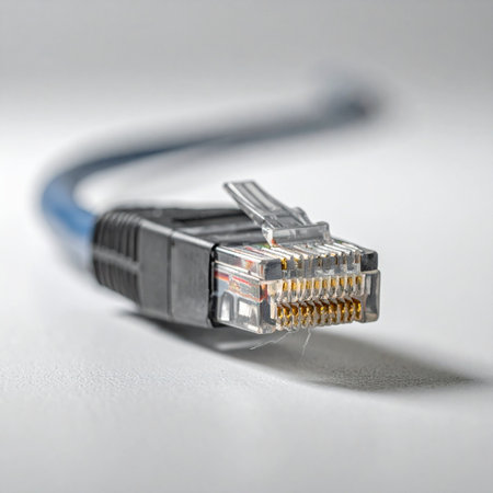 A macro view of a blue ethernet cable highlights the intricate gold-plated contacts of the RJ45 connector.の素材