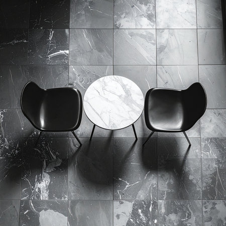 A top-down, black and white view of a minimalist meeting space. Two modern chairs face a round marble table, creating a sense of anticipation for a quiet, important conversation.の素材