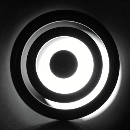 A stark, high-contrast image of glowing concentric circles creating a hypnotic effect.の素材