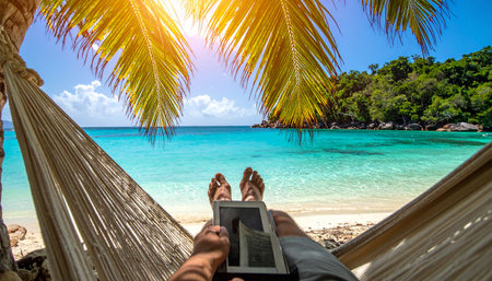 A first-person perspective of ultimate relaxation. Lying in a hammock under shady palm trees with feet up, overlooking a stunning turquoise ocean.の素材