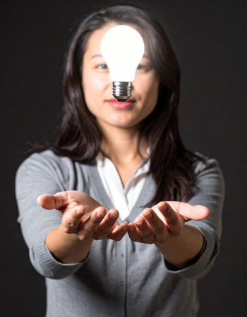 A creative professional presents a brilliant, glowing idea.の素材